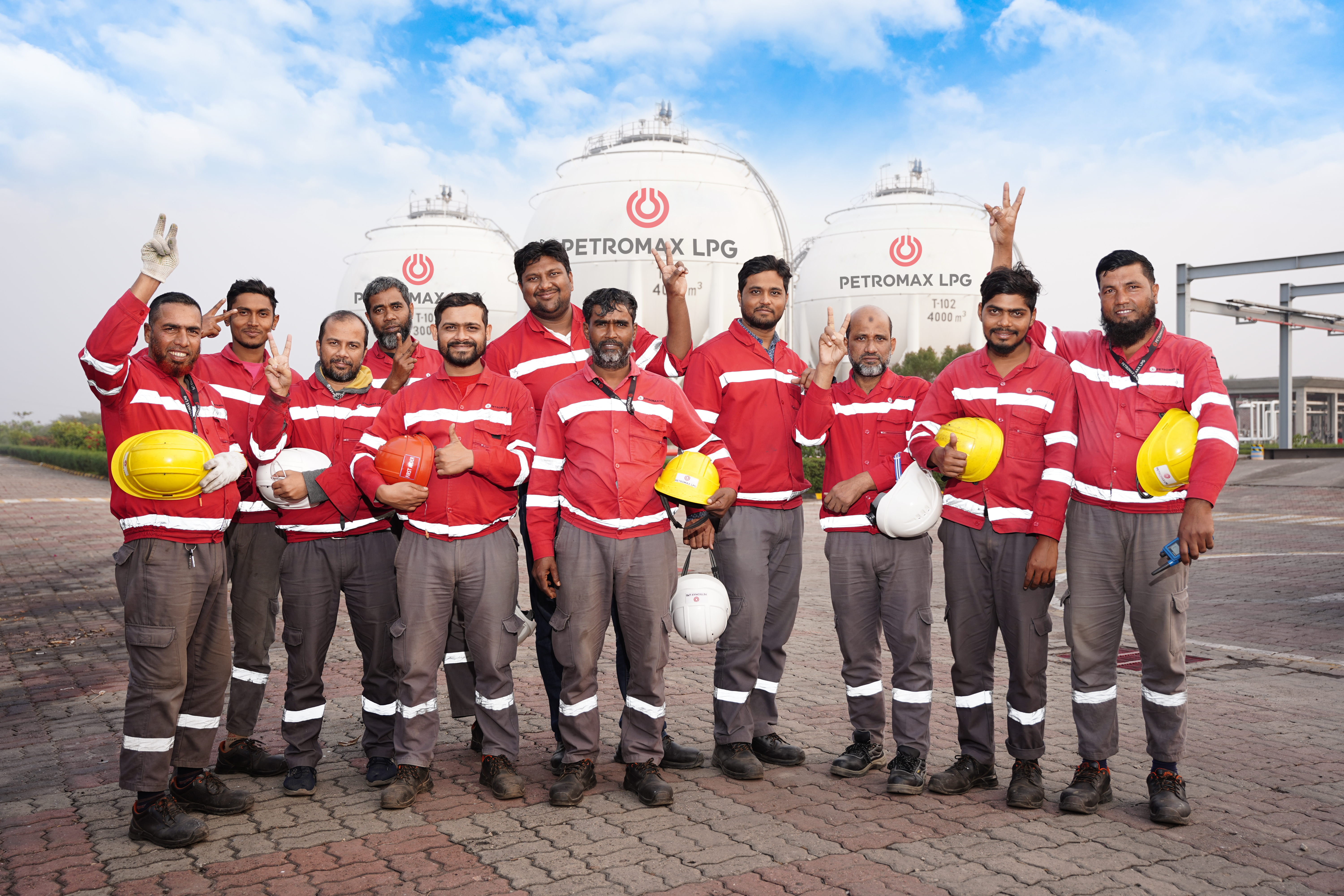 Team of Petromax LPG plant workers standing in front of industrial facility in Bangladesh
